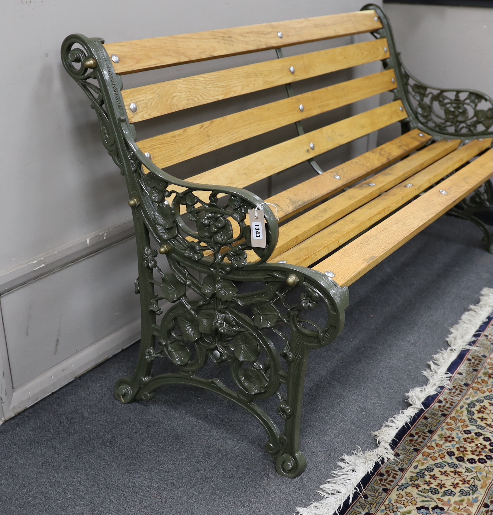 A Victorian Coalbrookdale 'nasturtium' pattern cast iron garden bench restored with later oak slats, length 146cm, depth 64cm, height 81cm